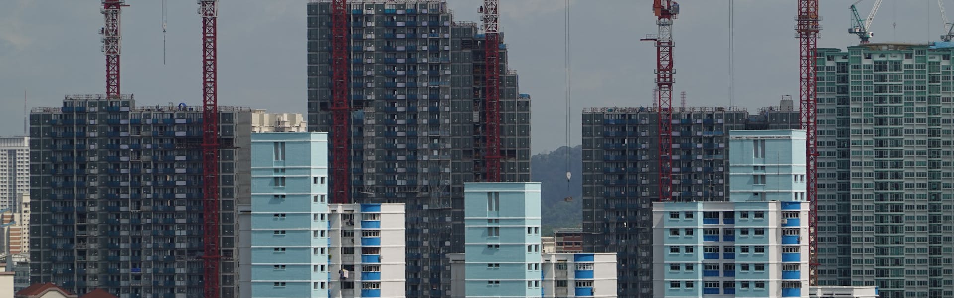 Construction site with cranes over Singapore high-rise buildings