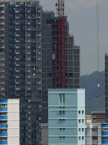 Construction site with cranes over Singapore high-rise buildings